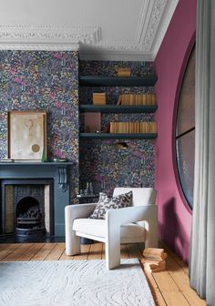 a living room filled with furniture and a fire place in front of a book shelf