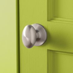 a green door with two knobs on it