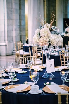 the table is set with place settings and centerpieces for an elegant wedding reception