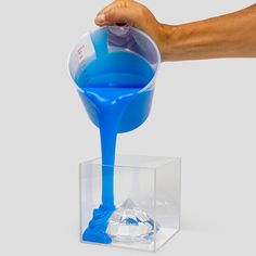 a person pouring blue liquid into a container with the words safe to use on it