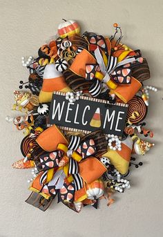 a welcome wreath made out of halloween decorations