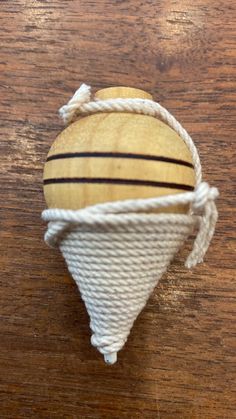 a wooden object with rope wrapped around it