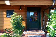 the front door of a small wooden house