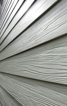 the side of a house with white siding and woodgrains on it's sides