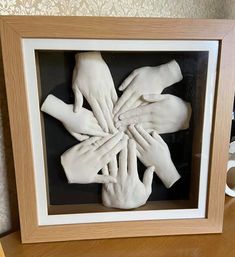 there are many hands together in a shadow box