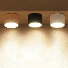 three lights that are on the side of a wall