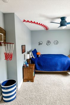 a bedroom with a blue bed and basketball hoop