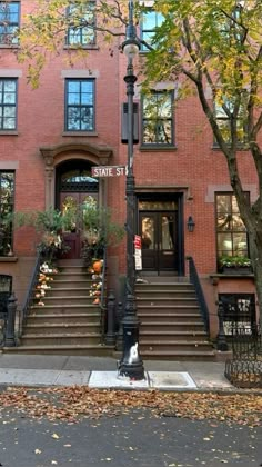 an apartment building with stairs leading up to the front door