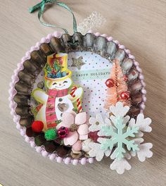 an ornament is sitting on a table next to other ornaments and decorations that include snowflakes