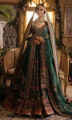 a woman in a green and gold wedding gown