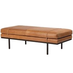 a brown leather bench sitting on top of a metal frame