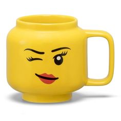 a yellow mug with a face drawn on it