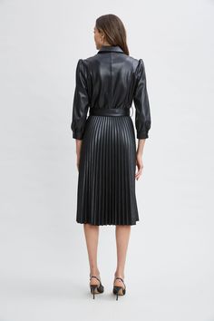 Meet our modern, endlessly versatile Vegan Leather Shirtdress that's infused with an edgy feminine vibe. The sporty shirt-dress silhouette, self-belt & pleated midi skirt give it the cool factor you want for easy Fall days. Dress it up with heels or down with sneakers- effortlessly chic either way. T-Tahari Vegan Leather Long Sleeve Belted Pleated Midi Dress 100% Polyurethane Runs true to Size Model is 5'9" and wearing size S Dry Clean Only Imported Style #: THF49028 Knee-length Midi Dress For Work With Pleated Back, Knee-length Midi Dress With Pleated Back For Work, Elegant Spring Belted Pleated Dress, Elegant Black Pleated Dress For Fall, Fitted Black Belted Knee-length Dress, Black Pleated Collared Dress, Black Collared Pleated Dress, Black Fitted Knee-length Belted Dress, Spring Evening Pleated Belted Dress