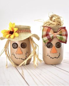 two mason jars with faces painted on them