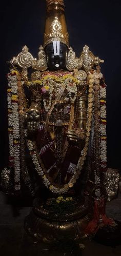 the statue is decorated with gold and jewels