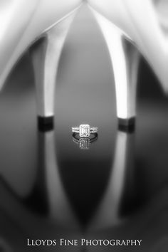 two wedding rings sitting on top of each other in front of a white background with the words lloyd's fine photography