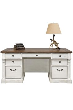 a white desk with drawers and a lamp