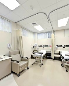 an empty hospital room with chairs and tables