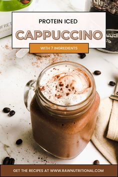 a glass jar filled with chocolate pudding and topped with whipped cream, on top of a table