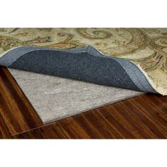 an area rug that has been placed on the floor with a wooden flooring board underneath it