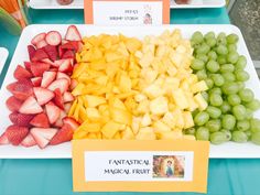 there are many different types of fruit on the table for sale at this event, including grapes, strawberries, and melon