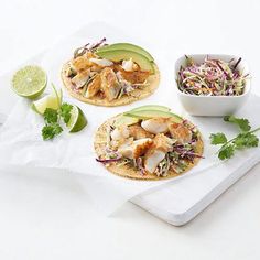 three tacos with shrimp, lettuce and cole slaw