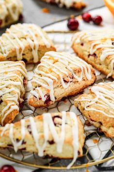 cranberry scones with icing sitting on a cooling rack, ready to be eaten