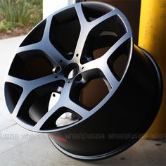 a black wheel is sitting on the ground