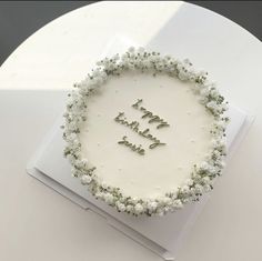 a white cake with the words happy birthday written on it