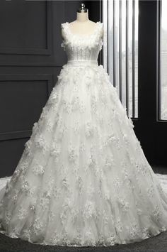 a white wedding dress on display in front of a window