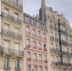 some very tall buildings with balconies on the top and bottom floors in paris