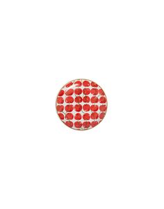 a red and white polka dot button on a white background