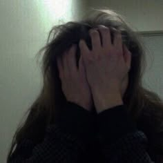 a woman with long hair covering her face