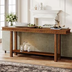 a console table with candles and flowers on it