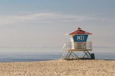 a lifeguard tower sitting on top of a sandy beach