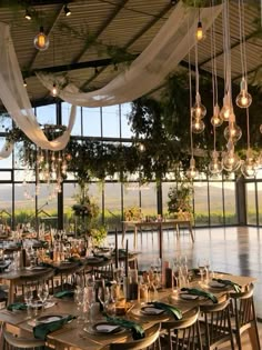 an indoor dining area with lots of tables and chairs set up for a formal function