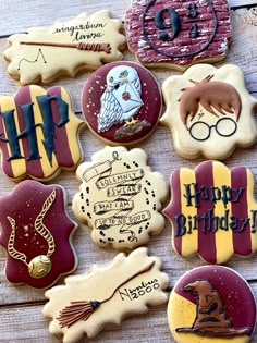 harry potter themed cookies are arranged on a wooden table with the words happy birthday written in different languages