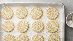 iced cookies on a baking sheet with icing drizzled around the edges