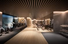 a gym with rows of exercise bikes and treadmills