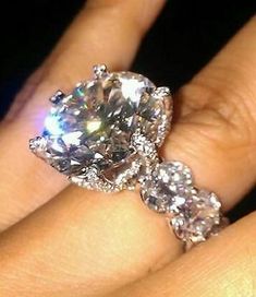 a woman's hand with a diamond ring on it and the price is $ 99 00