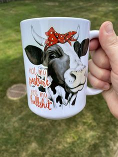 a hand holding a coffee mug with a cow on it's side and the words, i am not sure you are bullish