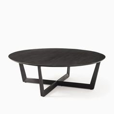 an oval table with black metal legs and a wooden top, against a white background