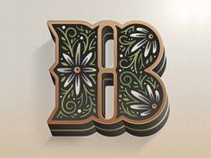 the letter b is decorated with flowers and leaves