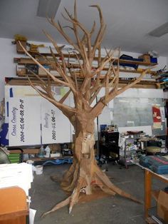 a tree that has been made out of cardboard and is in the middle of a room