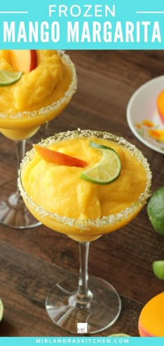 two glasses filled with mango margaritas on top of a wooden table