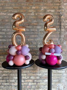 two black tables topped with balloons in the shape of numbers