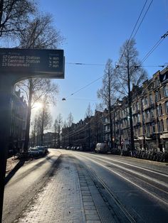 the sun is shining down on an empty street