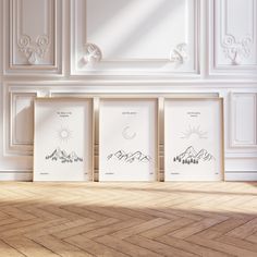 three framed pictures sitting on top of a hard wood floor next to a white wall