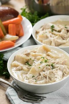 three bowls filled with chicken and dumplings next to carrots, celery