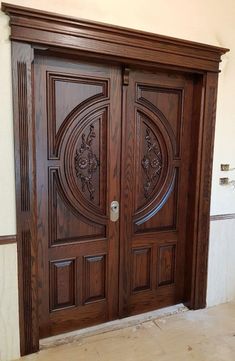 two wooden doors with intricate carvings on them